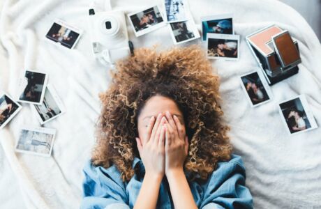 A young person resting their head amid scattered papers — Fetal Alcohol Spectrum Disorder (FASD) often makes memory and recall harder in the classroom
